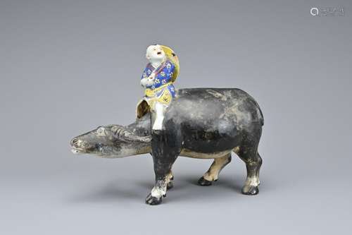 A CHINESE GLAZED CERAMIC FIGURE OF A BOY ON WATER BUFFALO, E...