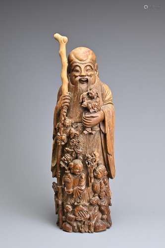 A LARGE CHINESE CARVED BAMBOO FIGURE OF SHOULAO, QING DYNAST...