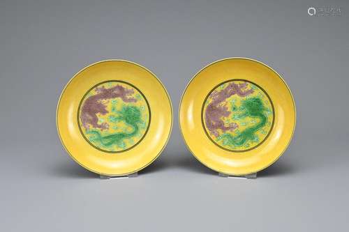 A PAIR OF CHINESE YELLOW GROUND GREEN AND AUBERGINE GLAZED D...