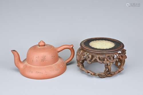 A CHINESE YIXING POTTERY TEAPOT AND CARVED WOOD STAND