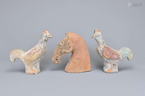 A CHINESE HAN DYNASTY PAINTED POTTERY HORSE HEAD AND TWO CHI...