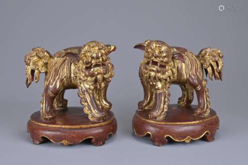 A PAIR OF CHINESE CARVED WOOD GILT LACQUERED LIONS