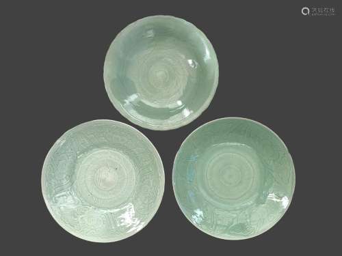 A Pair of carved celadon Chargers, and Another Similar, 18th...