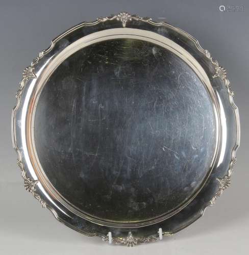 A George V silver circular salver with cast stylized flower ...