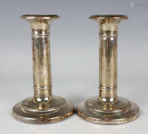 A pair of Edwardian silver candlesticks, each with a circula...