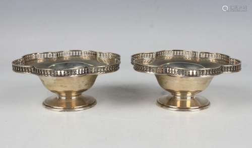 A pair of George V silver circular bonbon dishes, each lobed...