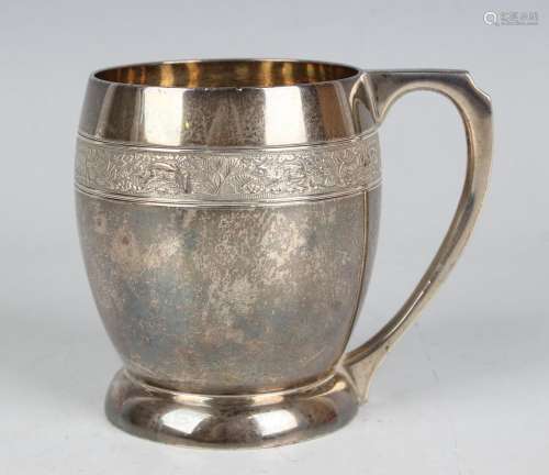 A George V silver christening mug of ovoid form, cast with a...