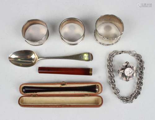 A small group of silver, comprising three napkin rings, teas...