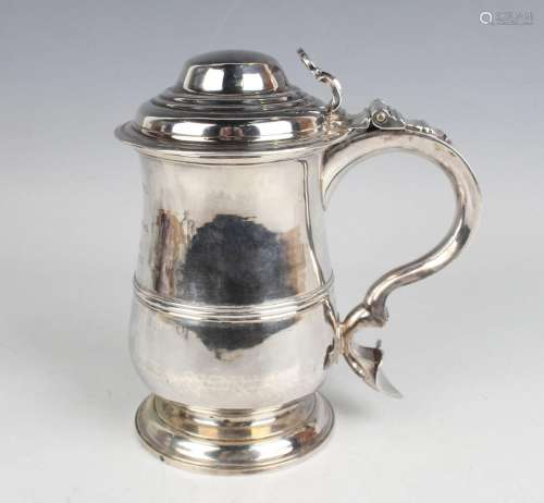 A George III silver tankard, the girdled baluster body with ...