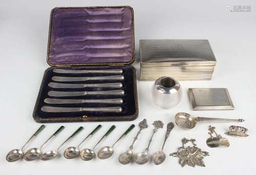 A small collection of silver, including a cigarette box with...