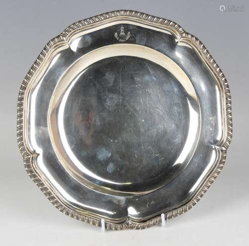 An Edwardian silver plate with shaped gadrooned rim and engr...
