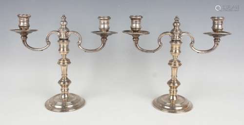 A pair of Elizabeth II silver twin scroll branch candelabra,...
