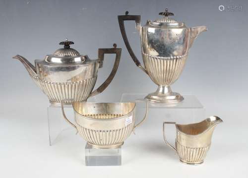 An Edwardian and later silver four-piece half-reeded tea set...