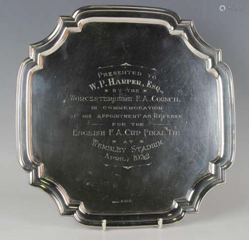A George V silver salver with shaped rim, the centre with en...