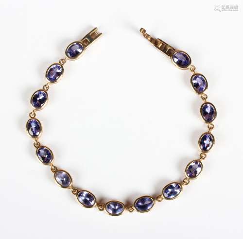 A 9ct gold and tanzanite bracelet, collet set with a row of ...