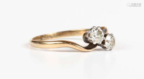 A gold and diamond two stone ring, claw set with cushion cut...