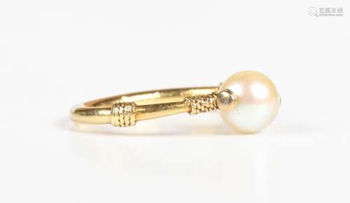 A gold ring, mounted with a single cultured pearl, unmarked,...