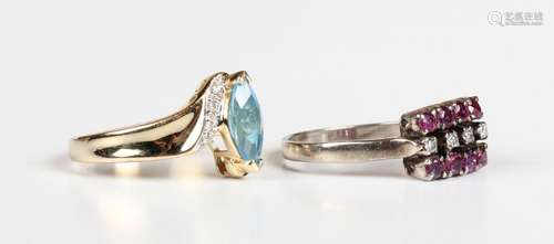 A gold, blue topaz and diamond ring in a crossover design, m...