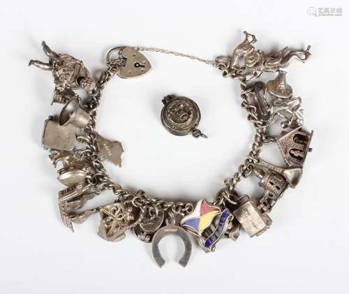 A silver curblink charm bracelet on a heart shaped padlock c...