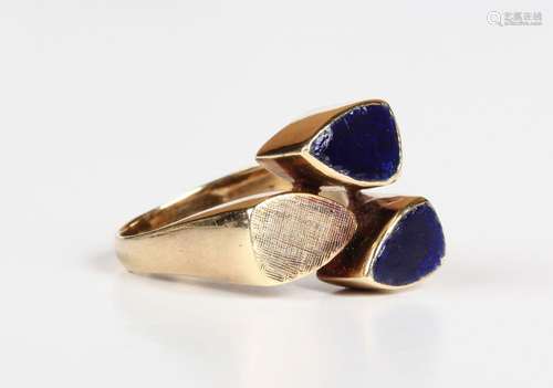 A gold ring in an abstract design with blue enamelled and te...