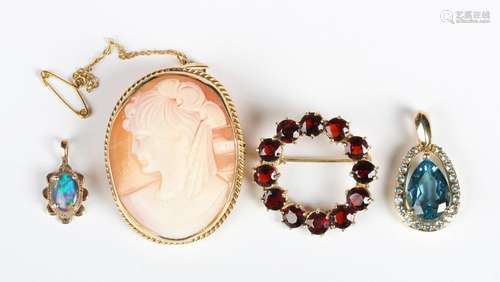 A gold and garnet circular brooch, detailed '375', a 9ct gol...