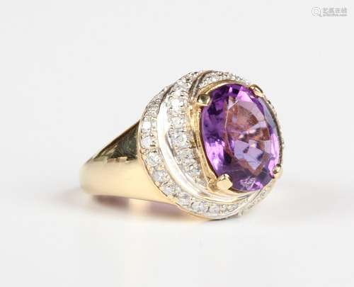 An 18ct gold ring, claw set with an oval cut amethyst within...