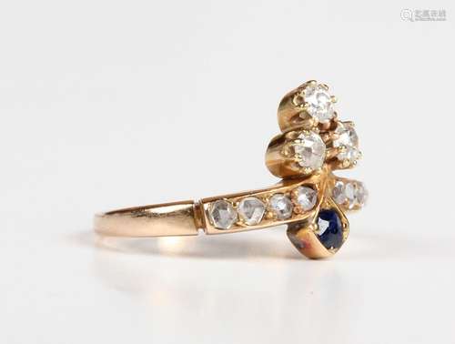 A gold, diamond and sapphire ring with a trefoil shaped moti...