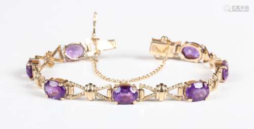 A 9ct gold and amethyst bracelet, claw set with a row of sev...