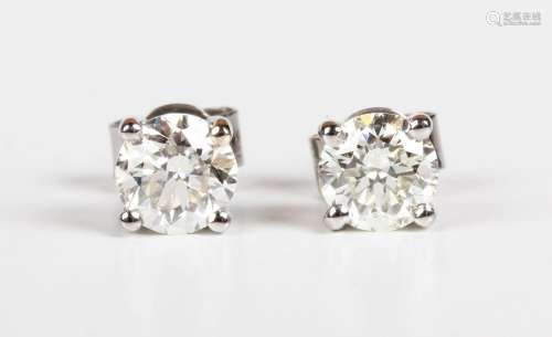 A pair of white gold and diamond solitaire earstuds, each cl...