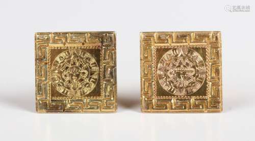 A pair of gold cufflinks, the square fronts with Aztec inspi...