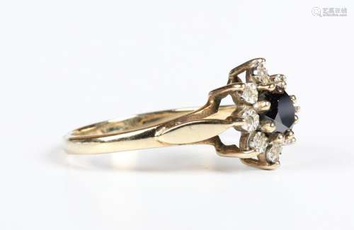 A 9ct gold ring, claw set with an oval cut black diamond wit...
