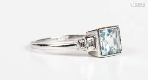 A platinum, aquamarine and diamond ring, collet set with a s...