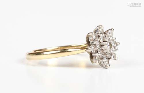 An 18ct gold and diamond cluster ring in a starburst shaped ...