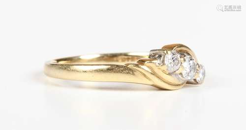 An 18ct gold and diamond three stone ring, claw set with a r...