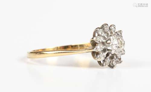 An 18ct gold and diamond cluster ring, mounted with the prin...