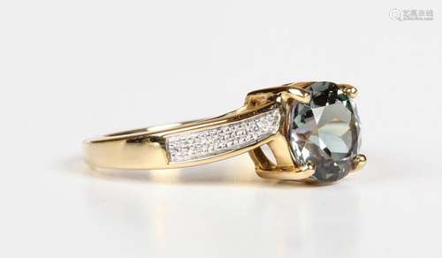 An 18ct gold ring, claw set with a circular cut green tanzan...