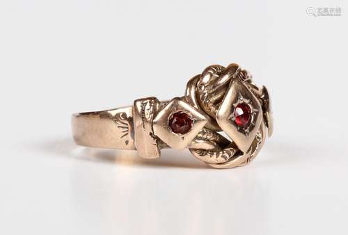 A 9ct gold and garnet three stone ring in a woven knot desig...