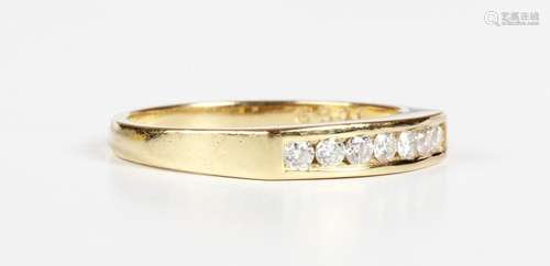 An 18ct gold and diamond seven stone ring, mounted with a ro...