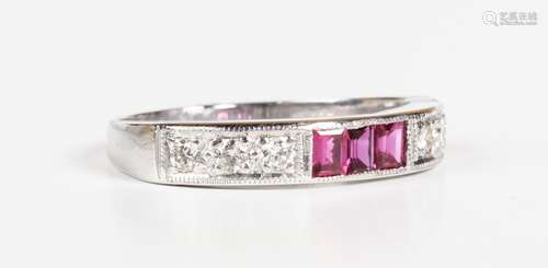 A white gold, ruby and diamond half eternity ring, mounted w...