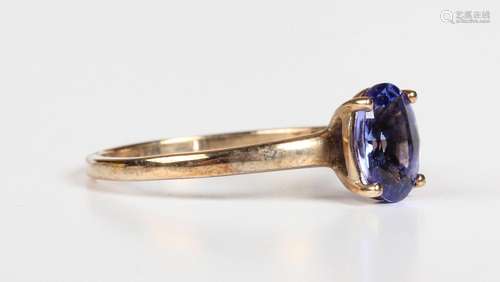 A 9ct gold ring, claw set with an oval cut tanzanite, Birmin...