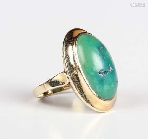 A gold and turquoise single stone ring, mounted with an oval...