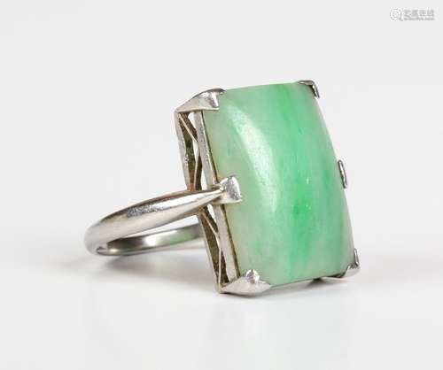 A platinum ring, 1920s, mounted with a rectangular jade, det...