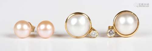 A pair of gold, diamond and cultured pearl earstuds, each mo...