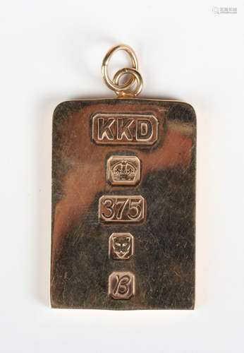 A 9ct gold rectangular ingot shaped pendant, London 1976, we...