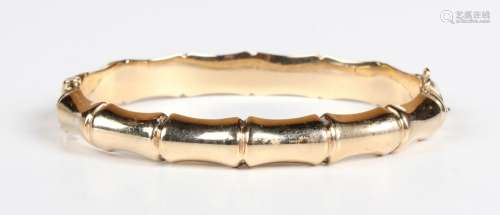 A 9ct gold oval hinged bangle in a bamboo design, on a snap ...