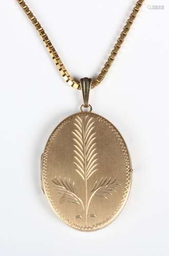A 9ct gold oval pendant locket, engraved with a fern spray, ...