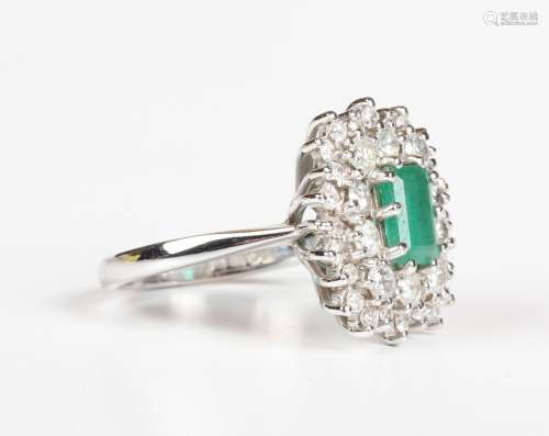 An 18ct white gold, emerald and diamond cluster ring, claw s...