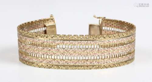 A 9ct three colour gold bracelet in a wide pierced link desi...