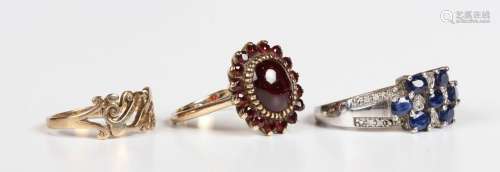 A gold and garnet oval cluster ring, detailed '9ct', ring si...