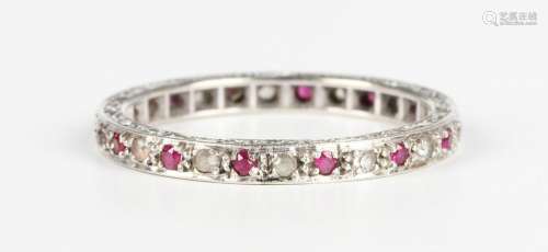 A white gold, ruby and colourless gem set eternity ring, mou...